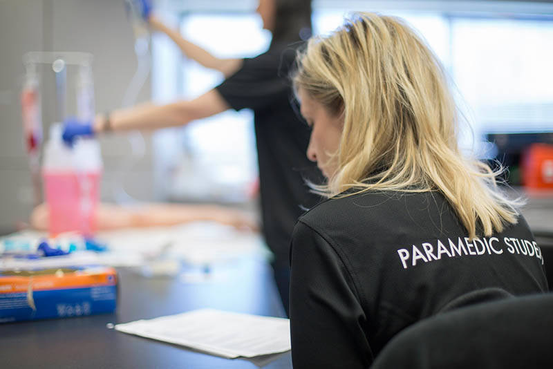 Paramedic student seated at desk